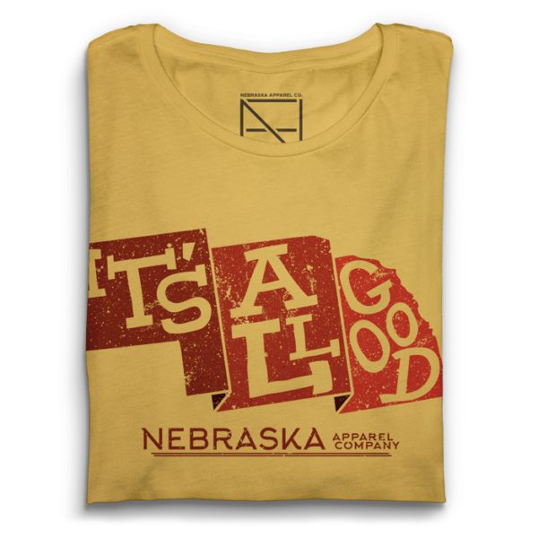 The phrase 'It's All Good' inside a state shape of nebraska in the color of red with the text 'Nebraska apparel company' on a yellow maze shirt with a deep red background.